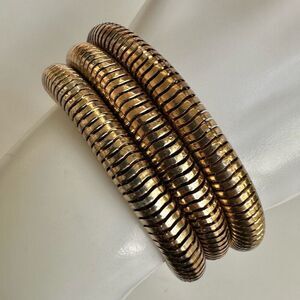 Gold tone triple strand bracelet